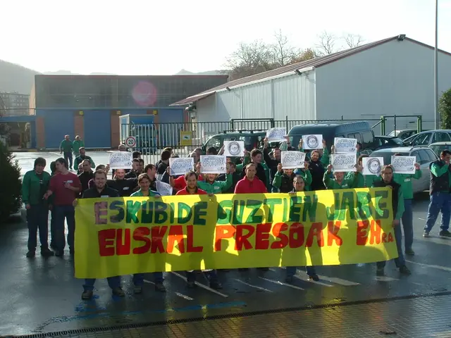 In this image there are many people holding papers with something written on that. In the front few...