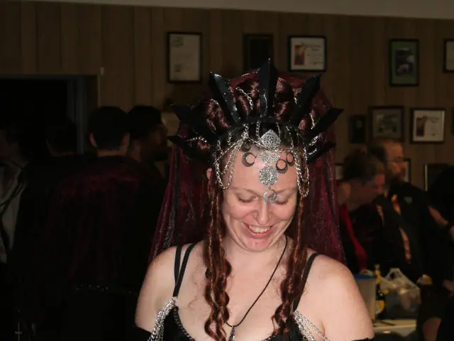 A beautiful girl is smiling, she wore black color dress. She is smiling.