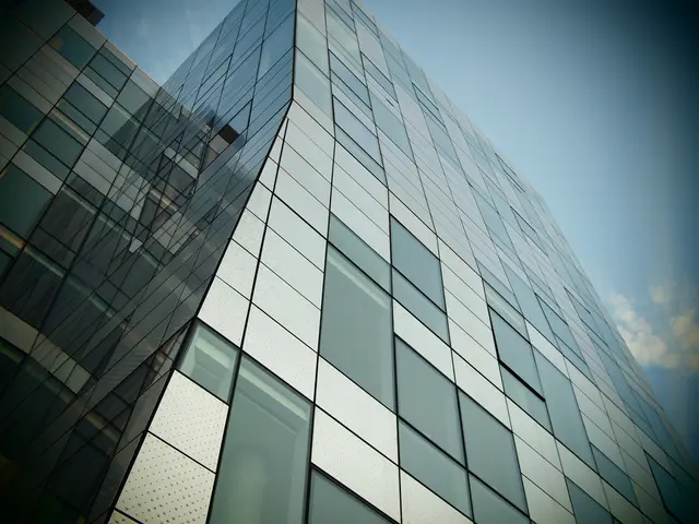 In this image we can see tallest glass building and at the top of the image there is clear sky.