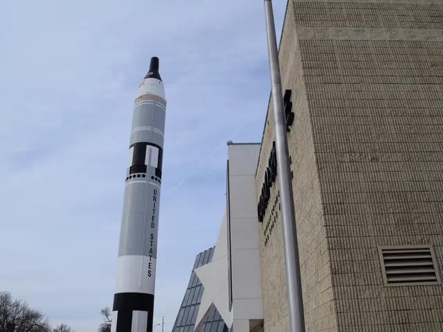 As we can see in the image there is a rocket, buildings, trees and sky.