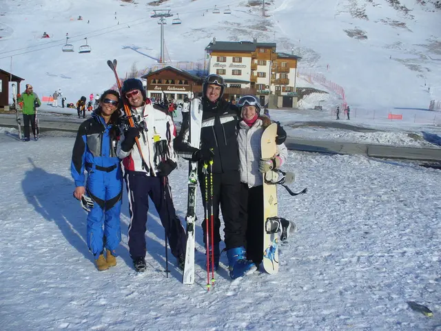 It is a a vacation destination there are four people posing for a photo they are holding skating...